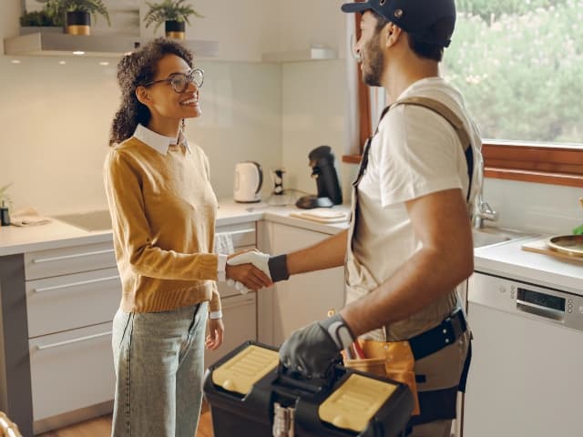 Client And Plumber Shaking Hands
